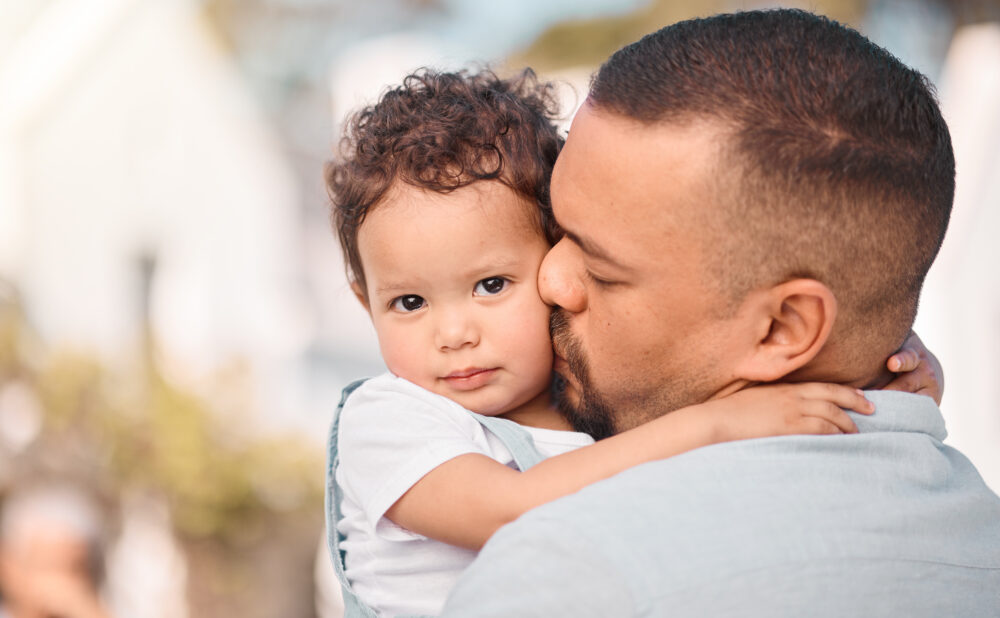 Love, dad and child hug, kiss and family bonding, support and trust in safety of parents embrace.